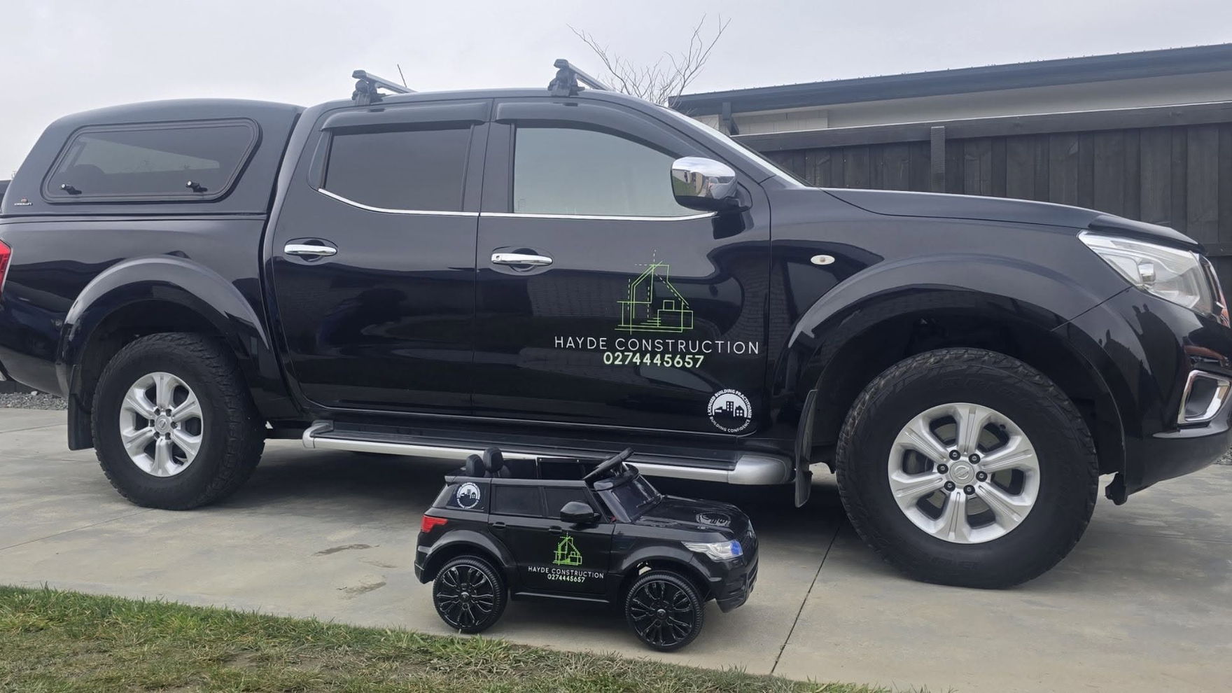 Black double-cab ute signwritten with the Hayde Construction logo, phone number and the Licensed Building Practitioner mark